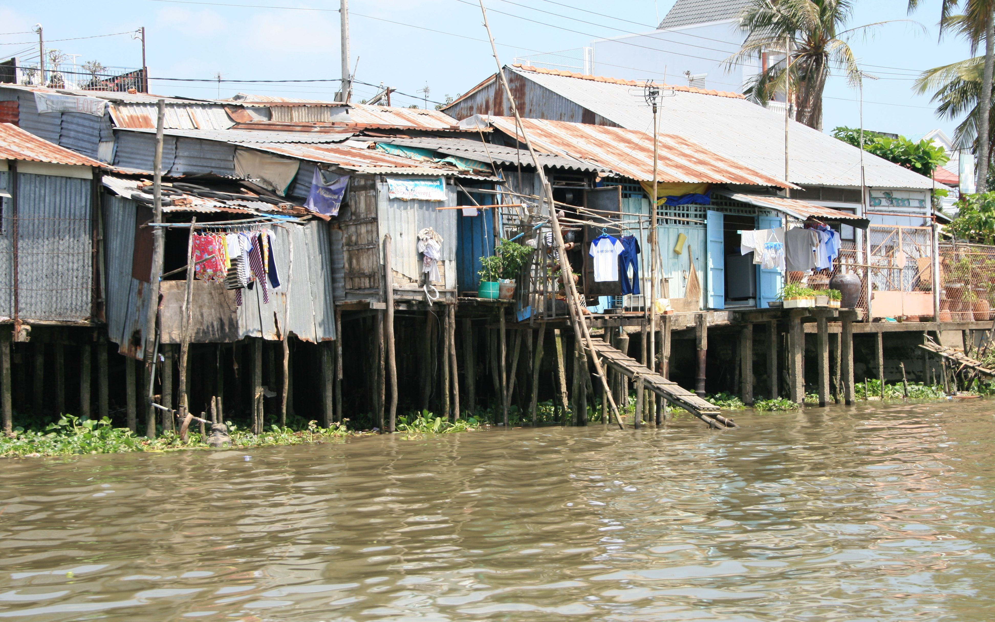 Stilt houses over water near floating market in the Mekong Delta