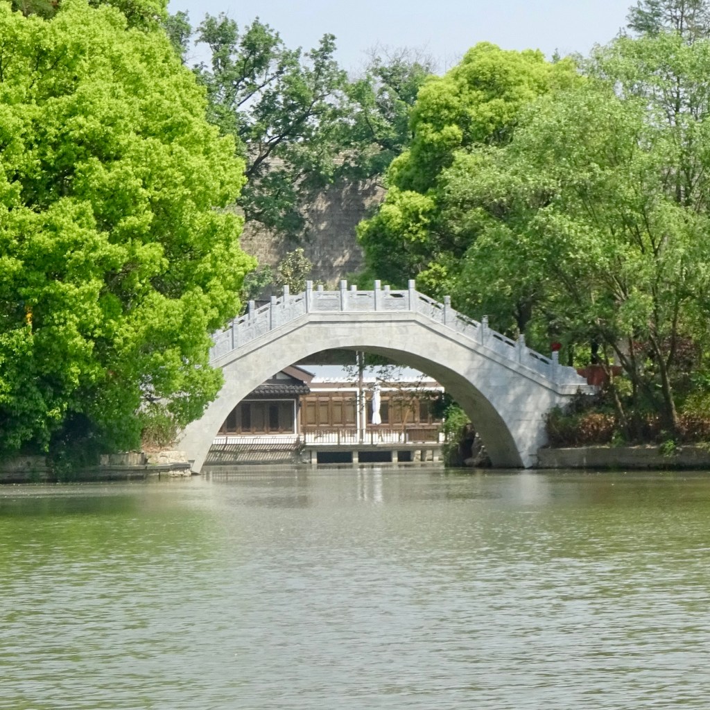 A traditional style chinese bridge over water at Houhai Lakes in Beijing, China